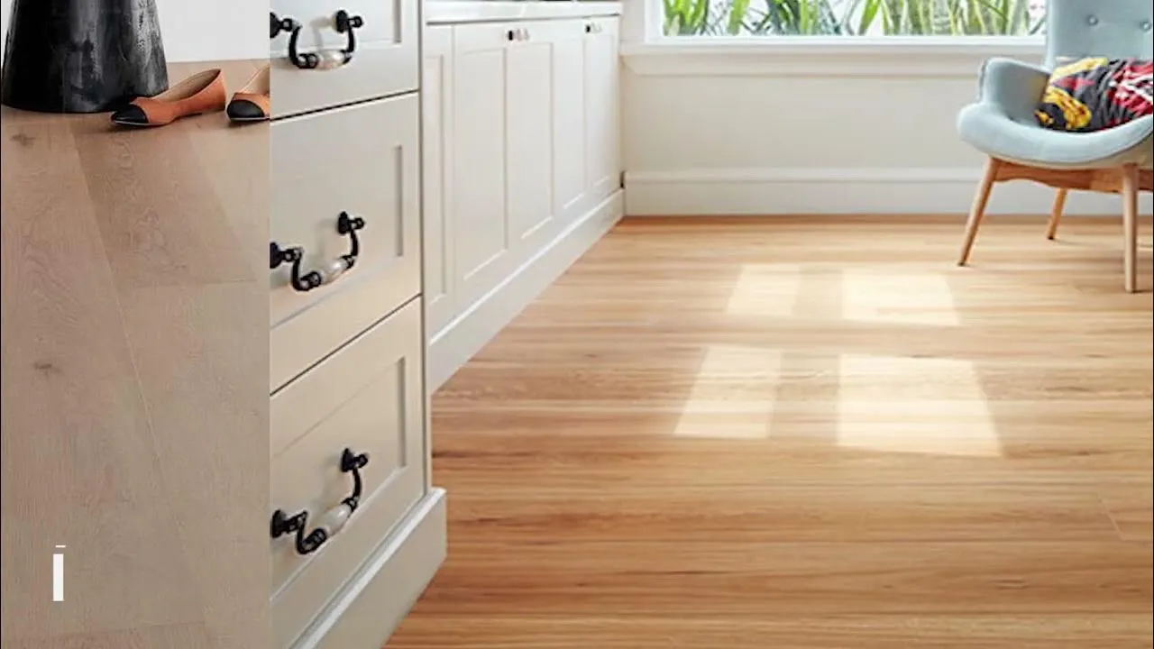 A split-screen comparison showing two types of light-colored wood flooring. On the left, a close-up of smooth, pale oak planks. On the right, a bright, sunlit room with wide-plank light timber floors, white kitchen cabinetry, and a modern blue armchair in the corner.