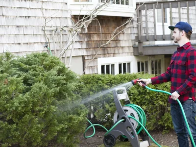 mid-adult-man-watering-plants-with-hosepipe-in-gar-2025-04-04-22-36-15-utc_11zon